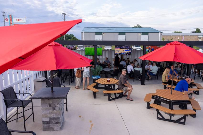 Red umbrellas and picnic tables on the Midway patio
