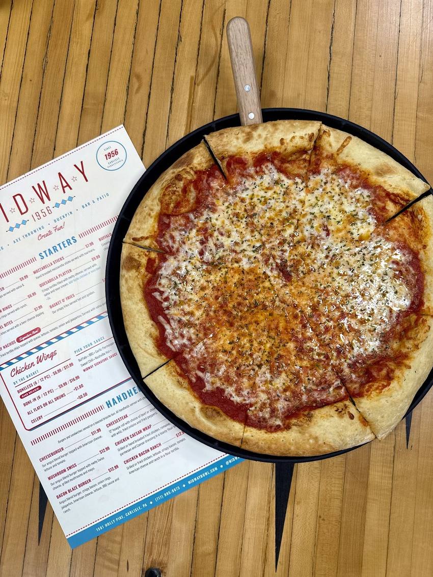 Pizza and the Midway menu on a lane-side table