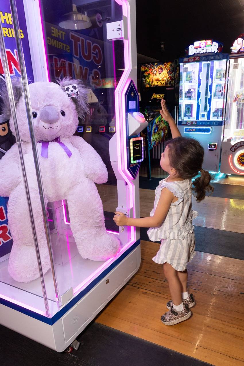 A birthday guest playing a claw machine