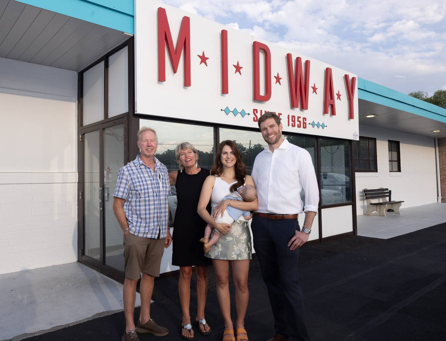 The Mowery family in front of the Midway sign